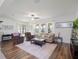 Bright living room with wood floors, neutral furniture, and sliding glass doors to the outside at 739 Annabell Ridge Rd, Minneola, FL 34715