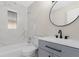 Modern bathroom featuring sleek fixtures, a large tub, and luxurious marble tile surround at 7427 Houston E Ct, Winter Park, FL 32792