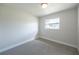 Bright, carpeted bedroom featuring a large window for plenty of natural light at 8042 Tompkins Sq, Orlando, FL 32807