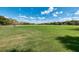 Expansive green field under a bright, partly cloudy sky offers plenty of open space at 8042 Tompkins Sq, Orlando, FL 32807