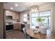 Stylish kitchen with stainless steel appliances, light cabinets and a view to the exterior at 8042 Tompkins Sq, Orlando, FL 32807