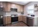 Modern kitchen featuring stainless steel appliances, light cabinets, and white countertops at 8042 Tompkins Sq, Orlando, FL 32807