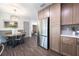 Bright kitchen and dining area featuring stainless steel appliances and modern cabinetry at 8042 Tompkins Sq, Orlando, FL 32807