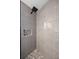 Walk-in shower featuring modern tile work, built-in niche, and rainfall shower head at 8042 Tompkins Sq, Orlando, FL 32807