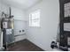 Bright utility room with a water heater, laundry hookups, a window for natural light and luxury vinyl plank flooring at 8042 Tompkins Sq, Orlando, FL 32807