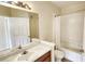 Bathroom with a single sink, tub, shower, and tiled floors at 8103 Lillies Way # 202, Orlando, FL 32825