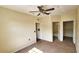 Neutral-toned main bedroom with a ceiling fan, two closets, and an en-suite bathroom at 8103 Lillies Way # 202, Orlando, FL 32825