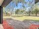 Large backyard with mature trees, blue skies, and beautiful green grass at 850 Rosalia Dr, Sanford, FL 32771