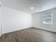 A well lit, white bedroom features a window and wood look floors at 850 Rosalia Dr, Sanford, FL 32771