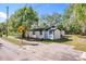Charming single-story home with black trim and a quaint, well-maintained front yard at 850 Rosalia Dr, Sanford, FL 32771