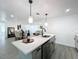 Open kitchen with pendant lighting, quartz countertops, and a view into the living room at 850 Rosalia Dr, Sanford, FL 32771