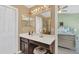 Bathroom vanity area showcases a large mirror and sink with direct access to a bright bedroom at 9130 Sabal Pine Way, Orlando, FL 32832