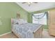 Bright bedroom features a comfortable bed with blue patterned bedding and natural light from the window at 9130 Sabal Pine Way, Orlando, FL 32832