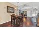 Charming dining area with hardwood floors, chandelier, and seamless flow to the living room at 9130 Sabal Pine Way, Orlando, FL 32832