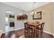 Elegant dining area with hardwood floors, chandelier, and convenient access to the kitchen at 9130 Sabal Pine Way, Orlando, FL 32832