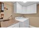 Laundry room with white washer, dryer and overhead storage at 1055 Kensington Park Dr # 402, Altamonte Springs, FL 32714