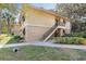 Exterior of a well-maintained two-story building with stairs leading to the front entrance at 120 Hibiscus Woods Ct # 13B, Deltona, FL 32725