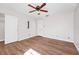 Bedroom featuring wood-look floors, a ceiling fan, a window, and a closet with an organizer at 127 Georgetown Dr # 127, Casselberry, FL 32707