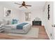 Staged bedroom featuring wood-look floors, a ceiling fan, a window, and a closet with an organizer at 127 Georgetown Dr # 127, Casselberry, FL 32707