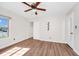 Bedroom featuring wood-look floors, a ceiling fan, a window, and a closet with an organizer at 127 Georgetown Dr # 127, Casselberry, FL 32707