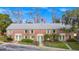 View of the brick facade with green doors and trim at 127 Georgetown Dr # 127, Casselberry, FL 32707