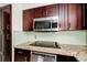 Close-up of a modern kitchen featuring stainless steel appliances and granite countertops at 127 Georgetown Dr # 127, Casselberry, FL 32707