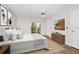 Nicely staged main bedroom featuring wood-look flooring, a ceiling fan, and a sliding glass door to the outside at 127 Georgetown Dr # 127, Casselberry, FL 32707