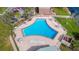 Aerial view of the community pool with plenty of seating, tables and sun loungers at 127 Georgetown Dr # 127, Casselberry, FL 32707