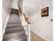 Carpeted staircase with white railing, hardwood banister, and tile landing at 127 Georgetown Dr # 127, Casselberry, FL 32707