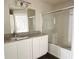 Bathroom with a granite countertop, large mirror, and enclosed bathtub and shower at 13028 Plantation Park Cir # 1218, Orlando, FL 32821