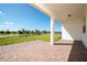 View of a brick back porch with a covered seating area and view of the lawn at 13270 Panama Beach Ct, Orlando, FL 32827