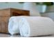 Close-up of rolled white towels on a bathroom countertop, showcasing clean and fresh spa details at 13270 Panama Beach Ct, Orlando, FL 32827