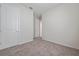 Cozy bedroom featuring neutral carpet, a closet, and an open doorway for versatile use of space at 13270 Panama Beach Ct, Orlando, FL 32827