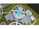 Aerial shot of the luxurious pool with palm trees, lounge chairs, and splash pad at the community's clubhouse at 13270 Panama Beach Ct, Orlando, FL 32827