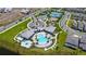 Aerial view of community amenities featuring the pool, clubhouse, tennis courts, basketball court, and playground at 13270 Panama Beach Ct, Orlando, FL 32827