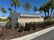 Entrance sign to Isles of Lake Nona. The landscaping shows various greenery and mulch at 13270 Panama Beach Ct, Orlando, FL 32827