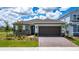 Charming home featuring stone accents, a brick driveway, and a two-car garage at 13270 Panama Beach Ct, Orlando, FL 32827