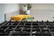 Close-up of a stovetop with yellow and green cloths on a granite countertop at 13270 Panama Beach Ct, Orlando, FL 32827