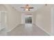 Spacious living room with fan, tile floors, and sliding glass doors to a balcony at 13500 Turtle Marsh Loop # 839, Orlando, FL 32837