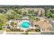 Aerial view of a community pool, clubhouse and palm trees at 13500 Turtle Marsh Loop # 839, Orlando, FL 32837