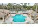 Aerial view of the community pool with decorative tile and lounge seating at 13500 Turtle Marsh Loop # 839, Orlando, FL 32837