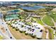 Aerial view showing tennis courts, a lake, a golf course and neighborhood in the background at 1440 Pro Shop Ct, Davenport, FL 33896