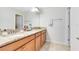 Bathroom featuring a double vanity with granite countertops and neutral colored flooring at 1440 Pro Shop Ct, Davenport, FL 33896
