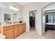 Vanity leading to a large walk-in closet and bright bedroom at 1440 Pro Shop Ct, Davenport, FL 33896