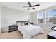 Cozy bedroom featuring two windows, carpet, and a ceiling fan for comfort at 1440 Pro Shop Ct, Davenport, FL 33896
