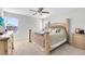 The bedroom features cozy carpet, a ceiling fan, and a traditional bed frame at 1440 Pro Shop Ct, Davenport, FL 33896