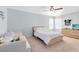 Relaxing bedroom with light blue walls, a ceiling fan, and large sunny windows at 1440 Pro Shop Ct, Davenport, FL 33896