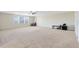 Expansive bonus room with large windows, neutral carpet, and ample space at 1440 Pro Shop Ct, Davenport, FL 33896
