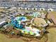 Overhead view of a community pool with water park, playground, and ample parking at 1440 Pro Shop Ct, Davenport, FL 33896