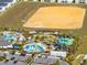 A high-angle view showcases the community pool with water slides and recreational areas at 1440 Pro Shop Ct, Davenport, FL 33896